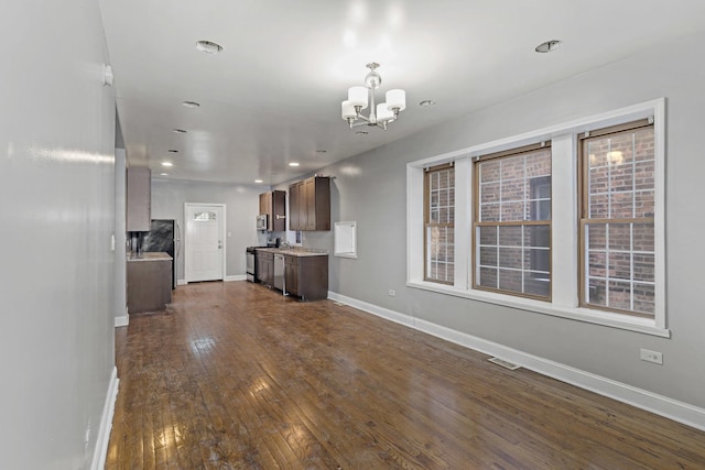 kitchen featuring dark wood-style floors, a notable chandelier, light countertops, visible vents, and baseboards