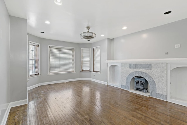 unfurnished living room featuring recessed lighting, dark wood finished floors, and baseboards