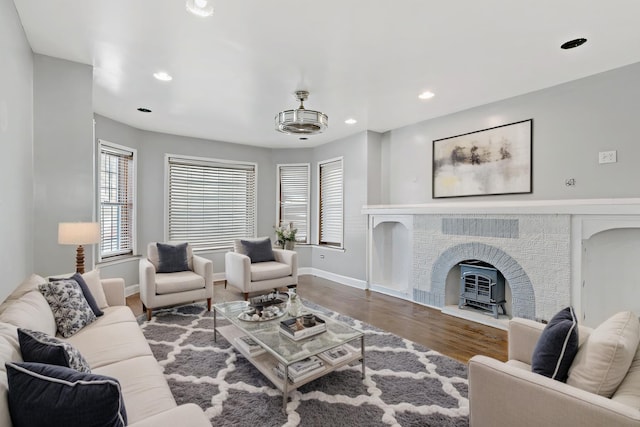 living room featuring baseboards, wood finished floors, and recessed lighting