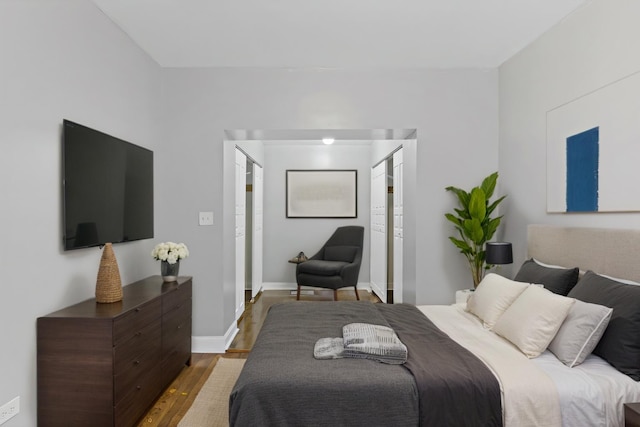 bedroom with wood finished floors and baseboards