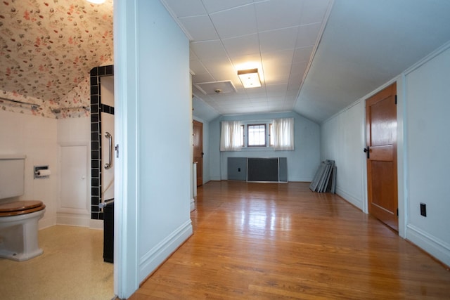 additional living space with lofted ceiling and wood finished floors