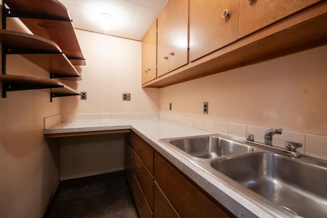 kitchen featuring light countertops, a sink, and open shelves