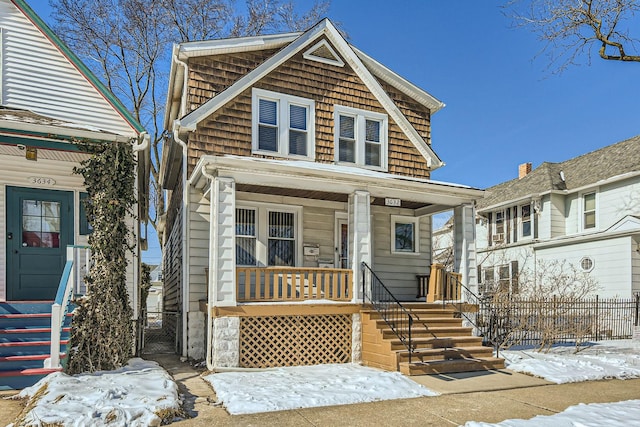 view of front of house with covered porch, fence, and a gate