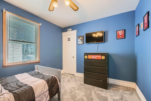 carpeted bedroom featuring ceiling fan and baseboards