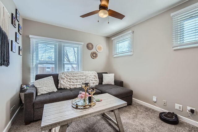 carpeted living room with baseboards, ceiling fan, and a healthy amount of sunlight