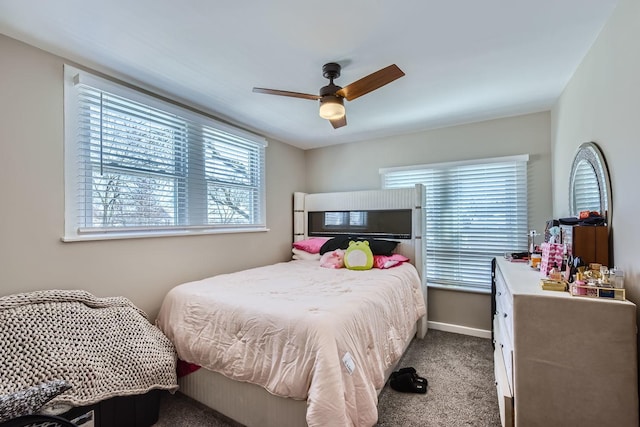 carpeted bedroom with baseboards and a ceiling fan