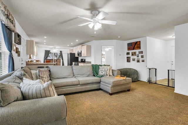 living room with light carpet, ceiling fan, and recessed lighting