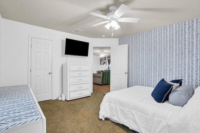 carpeted bedroom with ceiling fan and visible vents