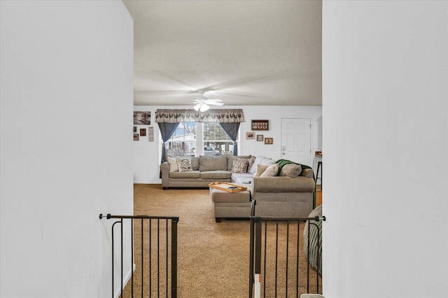 carpeted living area featuring ceiling fan