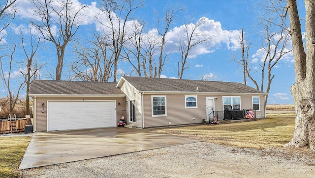 ranch-style home with a garage, a front yard, and concrete driveway