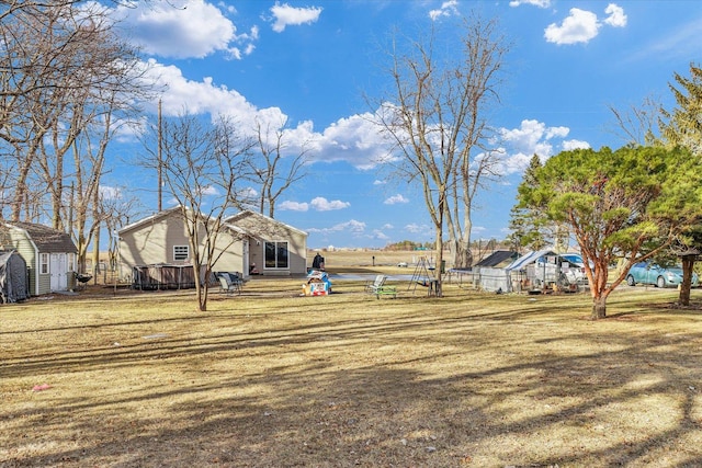 view of yard with an outdoor structure and a shed