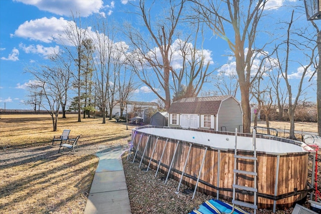 view of yard featuring an outbuilding and an outdoor pool