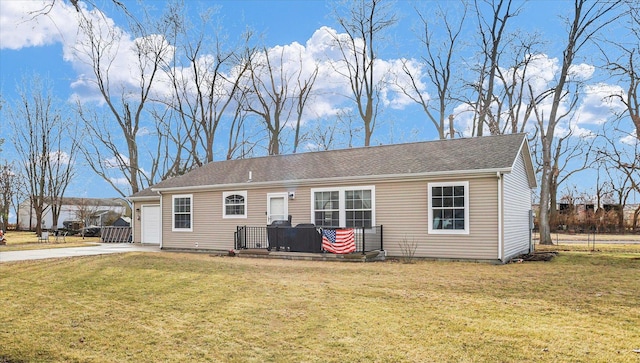 view of front facade featuring concrete driveway, an attached garage, a wooden deck, and a front lawn