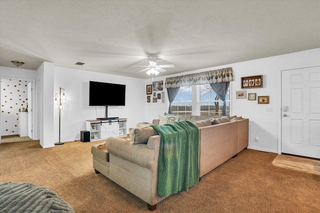 living room with baseboards, visible vents, ceiling fan, a textured ceiling, and carpet floors