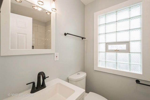 bathroom featuring toilet and vanity