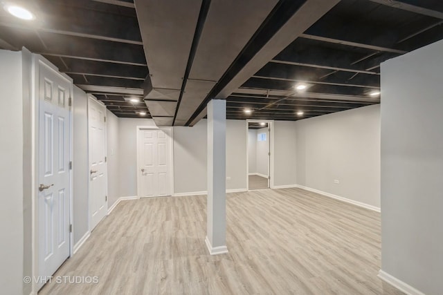 finished below grade area featuring light wood-style flooring and baseboards