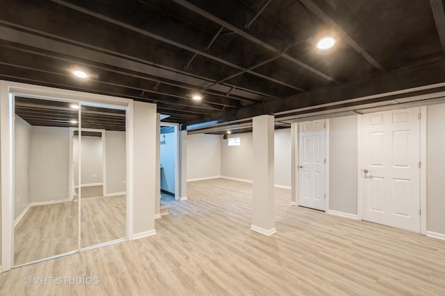 finished basement featuring baseboards and wood finished floors