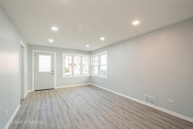 entryway with recessed lighting, visible vents, light wood-style flooring, and baseboards