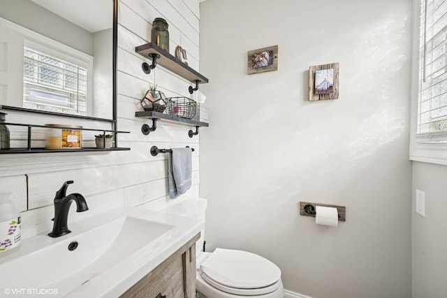 bathroom featuring decorative backsplash, vanity, and toilet