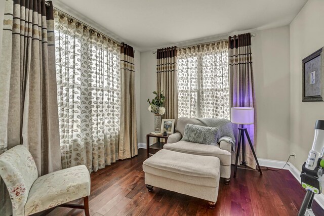 living area featuring wood finished floors and baseboards