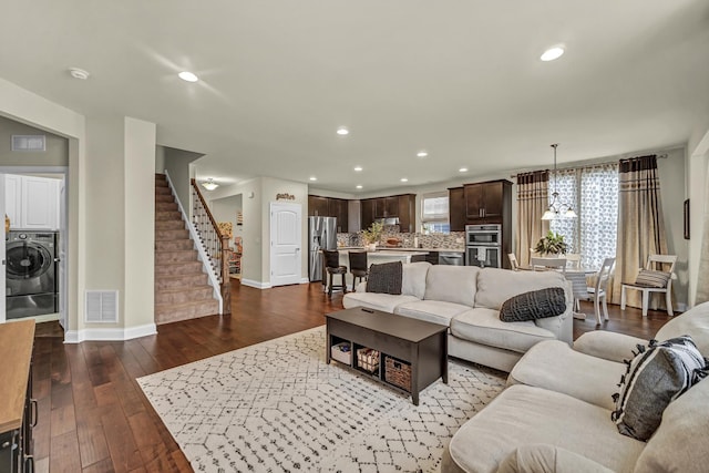 living room featuring recessed lighting, visible vents, stairs, washer / clothes dryer, and dark wood finished floors