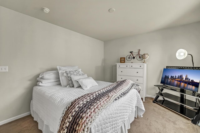 carpeted bedroom featuring baseboards