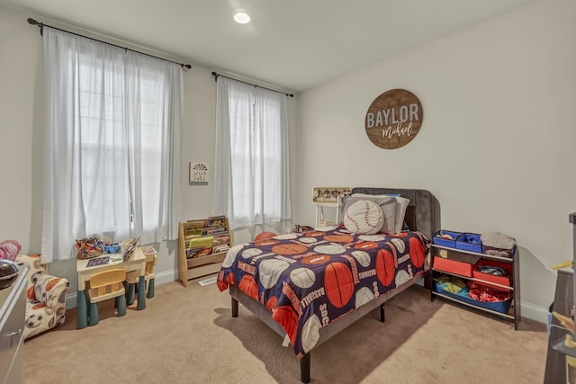 bedroom featuring carpet floors and baseboards