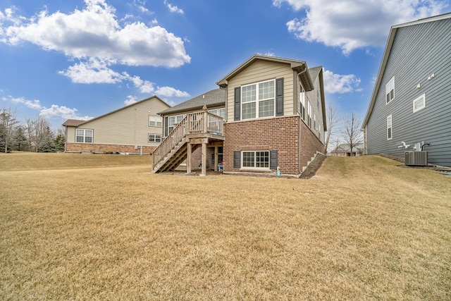 back of house with stairway, brick siding, a lawn, and central AC