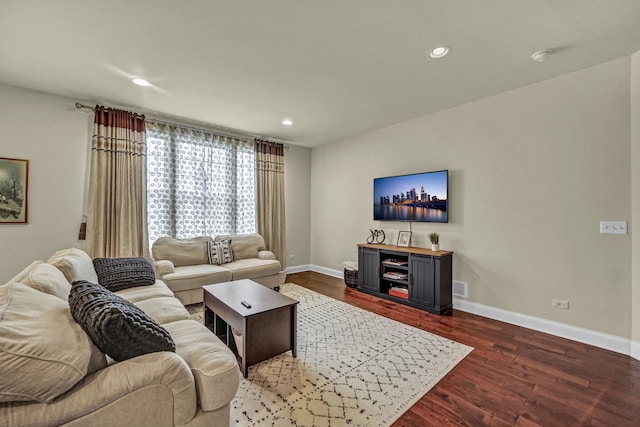 living area with visible vents, baseboards, wood finished floors, and recessed lighting