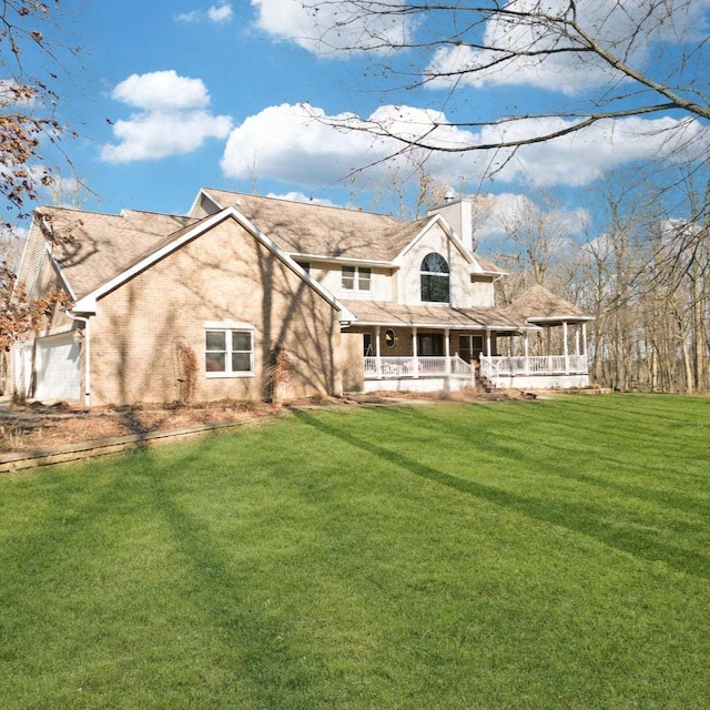 11307 Timber Lane Rd, Lena, IL 61048 - rear view of property with a porch, a chimney, an attached garage, and a yard