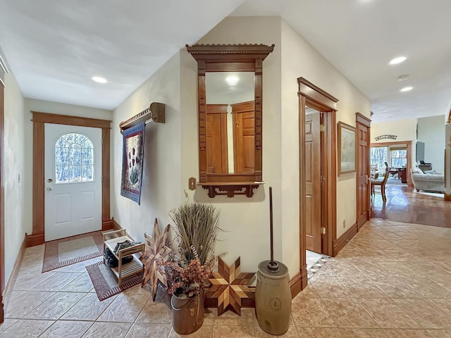 tiled entrance foyer with baseboards and recessed lighting