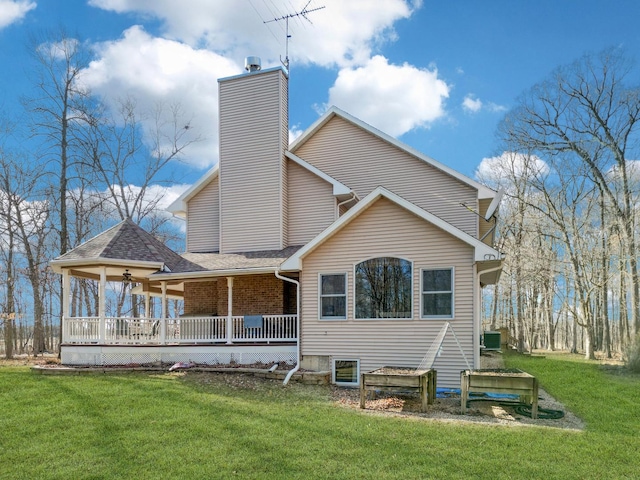 11307 Timber Lane Rd, Lena, IL 61048 - rear view of house featuring a yard, a chimney, and a porch