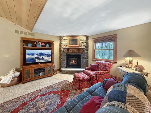 carpeted living room with visible vents, a fireplace, and baseboards