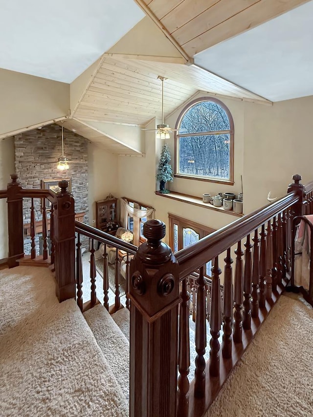 stairs with carpet flooring, vaulted ceiling, and ceiling fan