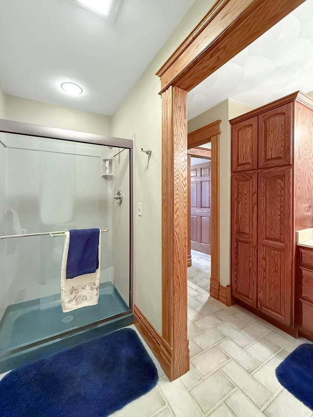 full bathroom with a shower stall and vanity