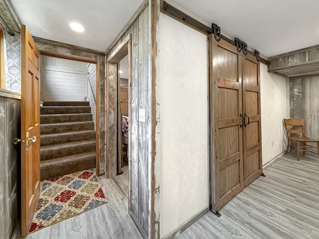 11307 Timber Lane Rd, Lena, IL 61048 - corridor featuring light wood-style flooring, stairway, and a barn door