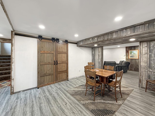 11307 Timber Lane Rd, Lena, IL 61048 - dining space with a barn door, wood finished floors, stairs, and recessed lighting