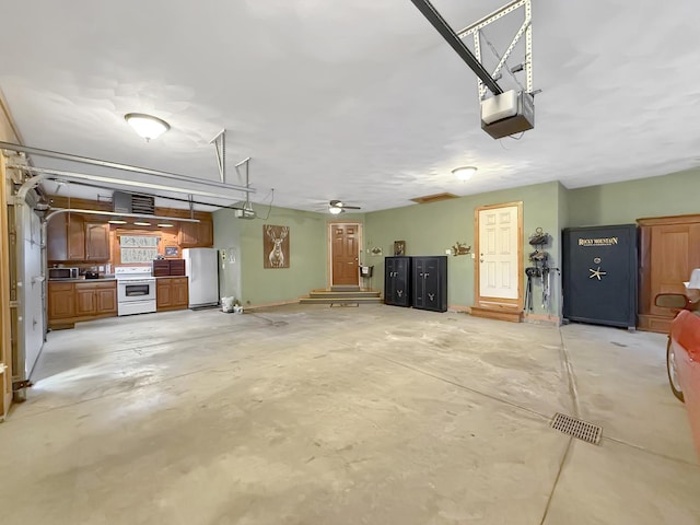 garage featuring a garage door opener and freestanding refrigerator