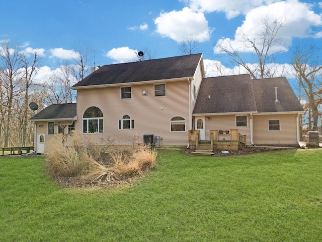 back of property featuring a deck, a yard, a chimney, and cooling unit