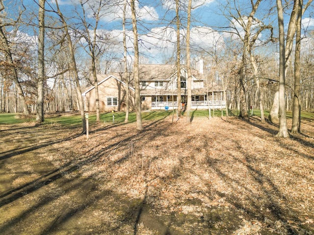 view of yard featuring covered porch