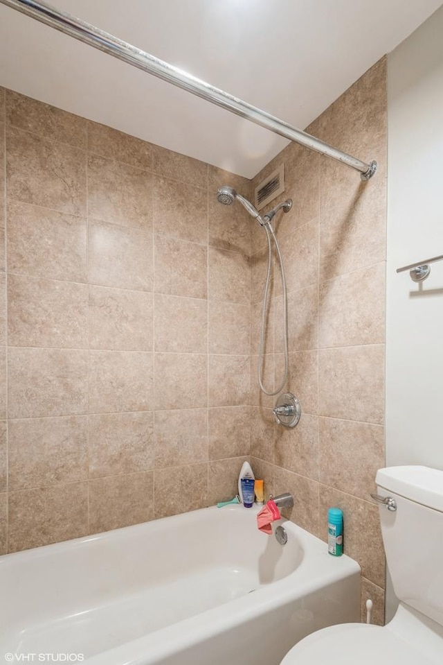 bathroom featuring toilet and shower / bathtub combination