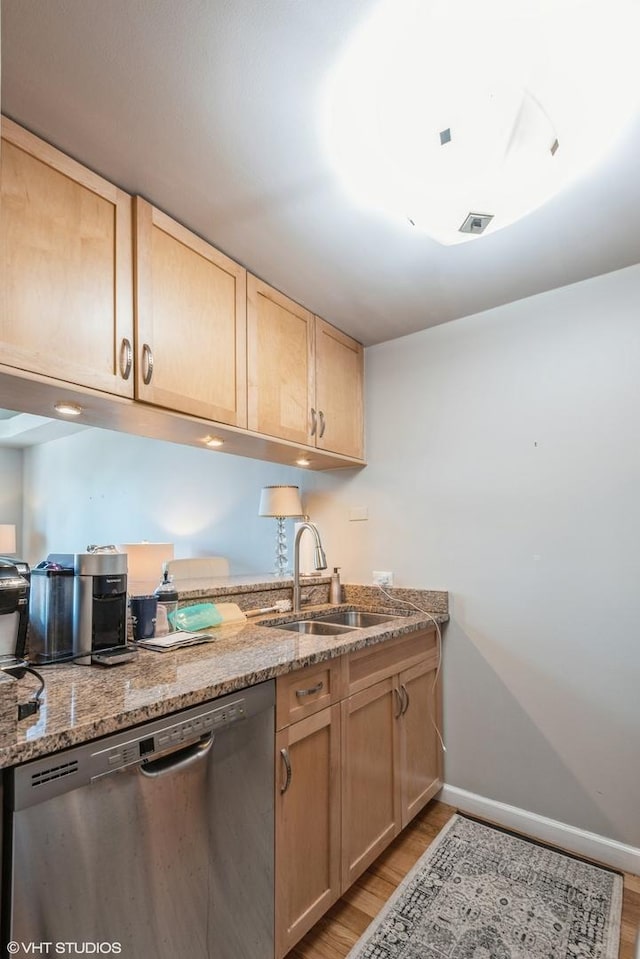 kitchen featuring a sink, light brown cabinets, and dishwasher