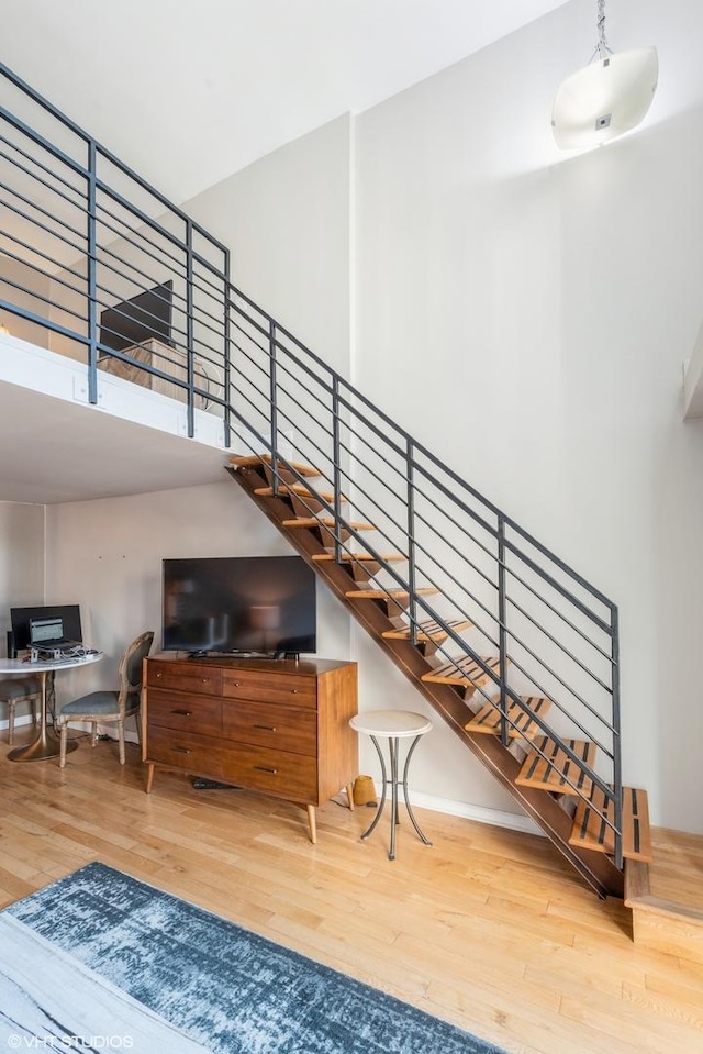 stairs featuring wood finished floors