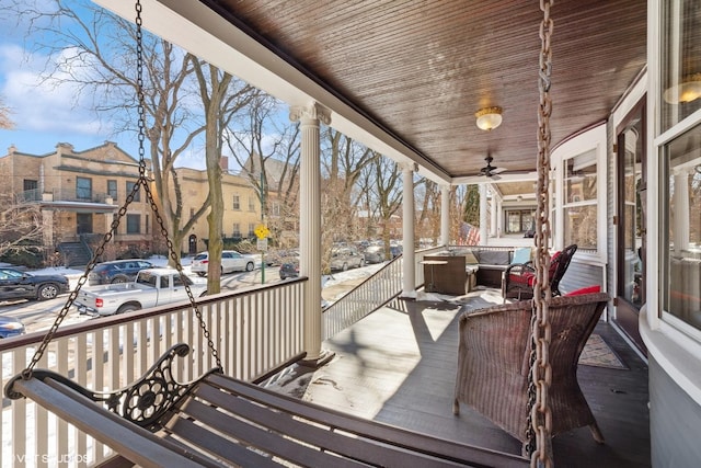 wooden deck with a residential view and covered porch