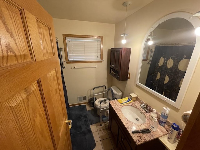 bathroom with toilet, tile patterned flooring, vanity, and visible vents