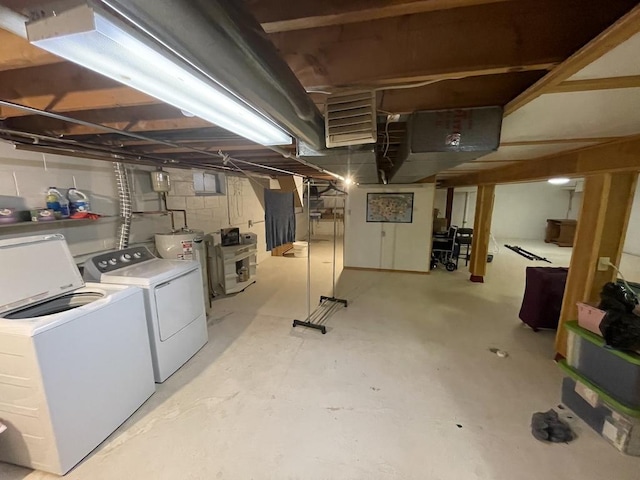 unfinished basement with water heater and washer and dryer