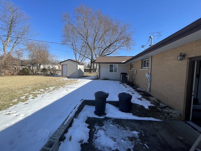 exterior space with brick siding, a storage shed, central AC, fence, and an outdoor structure