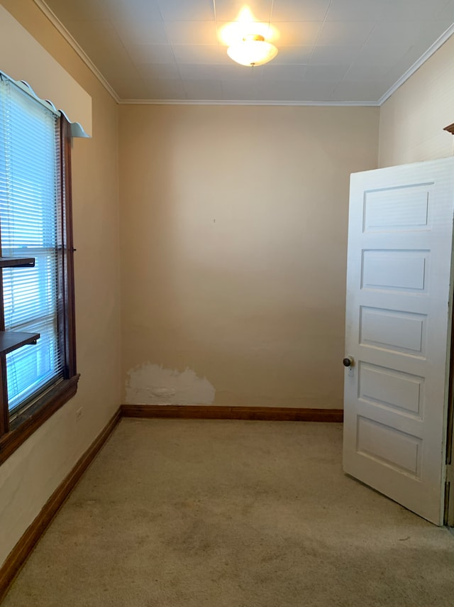 unfurnished room with light carpet, crown molding, and baseboards