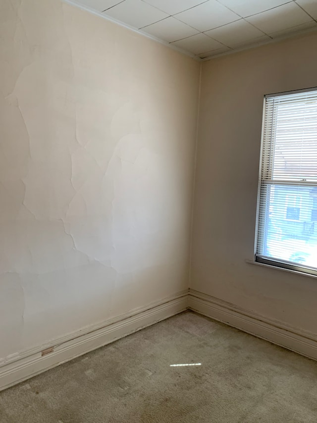 unfurnished room featuring light colored carpet