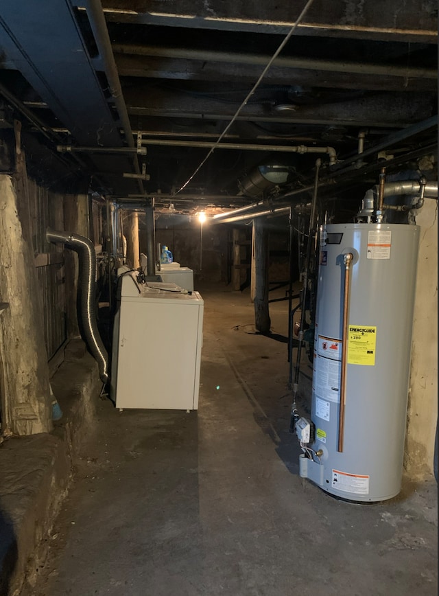 unfinished basement featuring water heater and washer / clothes dryer